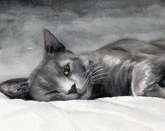 May include: Watercolor painting of a gray cat lying on a white surface. The cat is depicted in a relaxed pose, with its head tilted and eyes partially open. The artwork uses shades of gray and white, creating a soft, serene atmosphere.