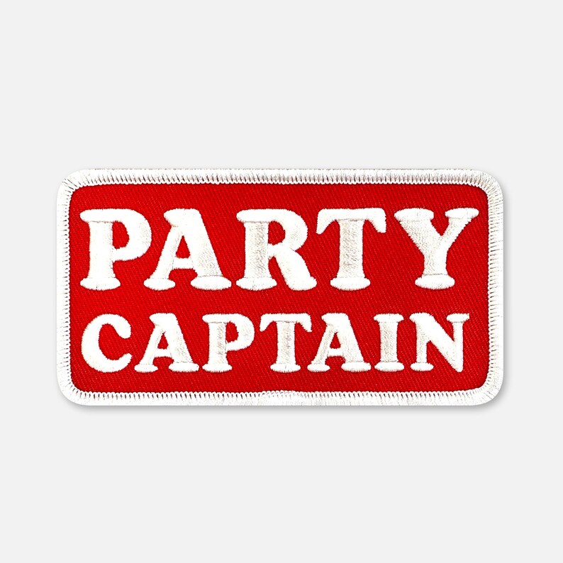 Puede incluir: Un parche rectangular bordado con un fondo rojo vibrante y un borde blanco. El texto PARTY CAPTAIN est&aacute; cosido en letras may&uacute;sculas blancas y negritas en el centro del parche, con un estilo de fuente claro y f&aacute;cil de leer.
