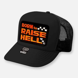 May include: A black trucker cap featuring a rectangular patch with the orange embroidered text BORN to RAISE HELL and a small checkered flag icon. The cap includes a black mesh back, a foam front panel, and a small sticker on the brim reading OTTO.
