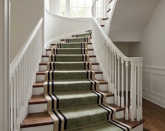 May include: A curved staircase featuring dark wood treads and white risers, accented by a sage green carpet runner with black and beige striped borders. The stairs are secured with brass rods and framed by white wooden balusters and a handrail.