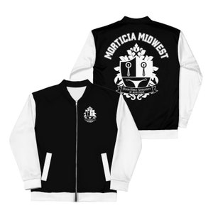 May include: Black and white bomber jacket with a zipper closure. The jacket features white sleeves and a black body. The front displays a white emblem, while the back showcases a larger emblem with the text "MORTICIA MIDWEST" and "FLASH-FORCE UNIVERSITY OF BURLESQUE."