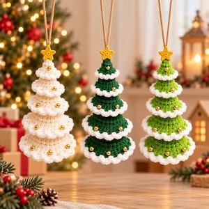 May include: Three hanging Christmas tree ornaments made of crocheted yarn. One is cream, one is dark green, and one is light green. Each tree features white scalloped edges, small gold beads, and a yellow crocheted star at the top.
