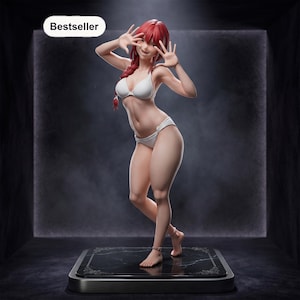 May include: A collectible anime-style figurine of a character with long red hair in a braid, wearing a white two-piece bikini. The figure stands on a black marble-patterned square base with a small tag labeled Bestseller in the upper corner.