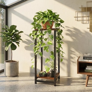 May include: A tall, rectangular plant stand featuring a dark metal frame and two wooden shelves. The top shelf holds a trailing green pothos plant in a terracotta pot, while the bottom shelf contains a small succulent and a black watering can.