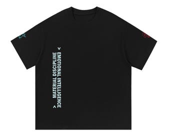 Puede incluir: Una camiseta negra de manga corta con texto vertical en blanco que dice EMOTIONAL INTELLIGENCE MATERIAL DISCIPLINE junto a símbolos de flechas. Las mangas muestran pequeños contornos gráficos coloridos de una figura azul y roja.