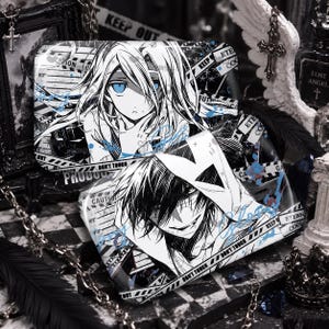 May include: Two rectangular metal cases featuring black and white anime-style illustrations. The top case depicts a character with long hair and blue eyes, while the bottom case shows a character with dark hair and a hood. Both feature caution tape text.