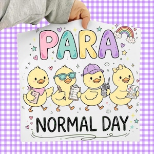 May include: A white sign featuring the text PARA NORMAL DAY in colorful bubble letters. Four yellow ducklings are illustrated below the text, each wearing accessories like a bandana, glasses, a cap, or a bow, and holding items like a clipboard or radio.