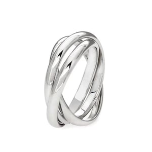 May include: A polished silver-toned ring featuring three interlocking bands that overlap to create a continuous, rounded shape. The metal surface is smooth and reflective, catching the light to highlight the curved contours of the design.