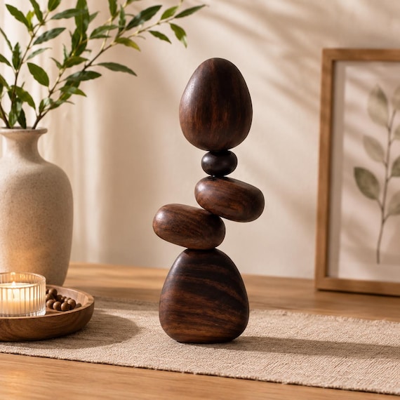 Hand-turned walnut stones that magnetically balance in impossible-looking stacked configurations — kinetic desk sculpture meets Zen fidget object.