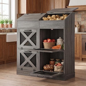 May include: A gray wood kitchen storage unit featuring two top-hinged bins for produce, two lower cabinets with X-patterned mesh doors, and an open shelving section. The unit holds potatoes, apples, carrots, and various jars on its open shelves.