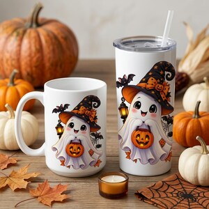 May include: A white ceramic mug and a white stainless steel tumbler, both featuring a cartoon ghost wearing a witch hat, holding a jack-o'-lantern, and accompanied by bats and a lantern. The items are set among various pumpkins and autumn leaves.