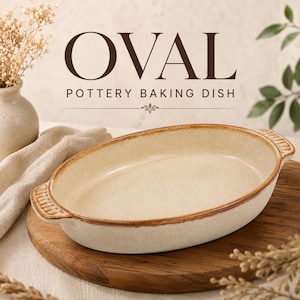 May include: An oval pottery baking dish with a speckled cream-colored interior and a textured brown rim. The dish features two small handles on opposite sides with a ribbed pattern. The text OVAL POTTERY BAKING DISH is visible above the dish.