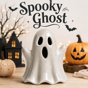 May include: A ceramic ghost figurine with a speckled off-white finish, featuring two oval eyes and an oval mouth opening. The text Spooky Ghost is printed above the figure, accompanied by two black bat silhouettes and small star accents.