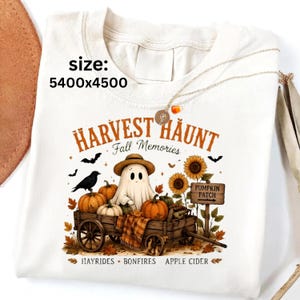 May include: A cream-colored t-shirt featuring a graphic of a ghost wearing a hat, sitting in a wooden wagon filled with pumpkins. The text reads HARVEST HAUNT, Fall Memories, PUMPKIN PATCH, and HAYRIDES, BONFIRES, APPLE CIDER. The size is 5400x4500.