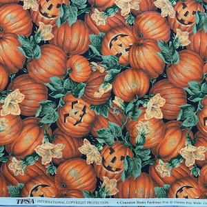 May include: A fabric print featuring a repeating pattern of orange pumpkins and jack-o'-lanterns with green leaves and pale yellow flowers on a black background. The bottom edge includes the text TPSA International Copyright Protection.