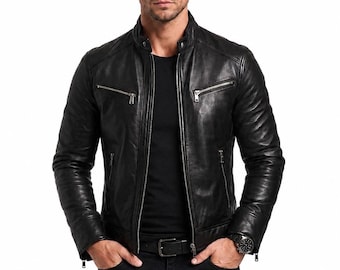 May include: A black leather jacket featuring a stand-up collar, a central silver-toned zipper, and two horizontal zippered chest pockets. The jacket has long sleeves with zippered cuffs and is worn over a plain black t-shirt and black jeans.