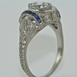 14kt White Gold and Diamond and Blue Sapphire Art Deco Design Hand Engraved Engagement RIng with a .55ct  Moissanite center stone