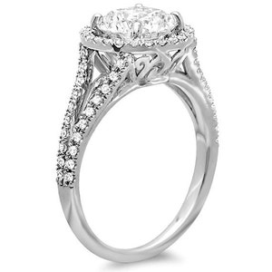 May include: A silver engagement ring with a large round center stone surrounded by a halo of smaller stones. The band is set with smaller stones and has a delicate, intricate design.