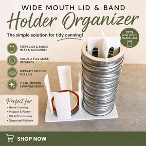May include: A white plastic wide mouth lid and band holder organizer featuring a vertical stack of metal canning bands and a separate section for flat lids. The product includes text labels describing its function for tidy canning storage.