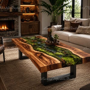 May include: A rectangular coffee table featuring a live edge wood slab with a central river-like inlay filled with green moss and resin. The table is supported by two black metal U-shaped legs, showcasing natural wood grain and organic textures.