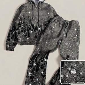 May include: A dark gray hoodie and matching sweatpants set featuring a black flame pattern and scattered clear rhinestones. An inset shows a 1cm x 1cm square detail of the fabric texture with individual rhinestones applied to the dark gray material.