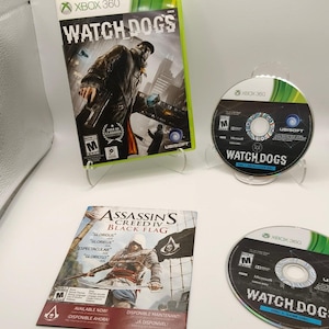 May include: An Xbox 360 Watch Dogs video game case, two game discs, and an Assassin's Creed IV Black Flag promotional insert. The game case features a character in a trench coat, while the discs are labeled Watch Dogs Disc 1 and Disc 2.