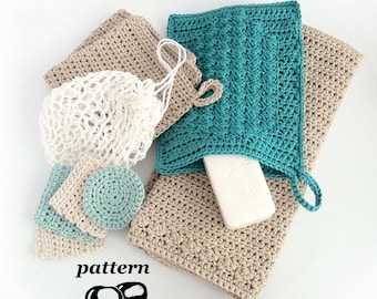 May include: A collection of crocheted items including beige and teal washcloths, a white mesh soap bag, and small round and square facial pads. A white rectangular bar of soap is tucked into the teal washcloth. The word pattern is printed below.
