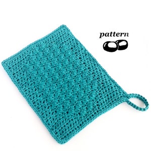 May include: Teal crochet dishcloth with a hanging loop. The dishcloth is made with a textured stitch pattern. "pattern" is written in black text above two black circles.