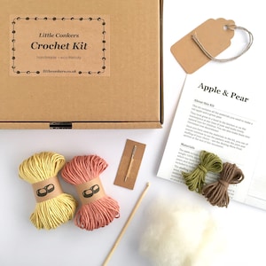 Crochet kit with yarn, stuffing and a crochet hook in a kraft box