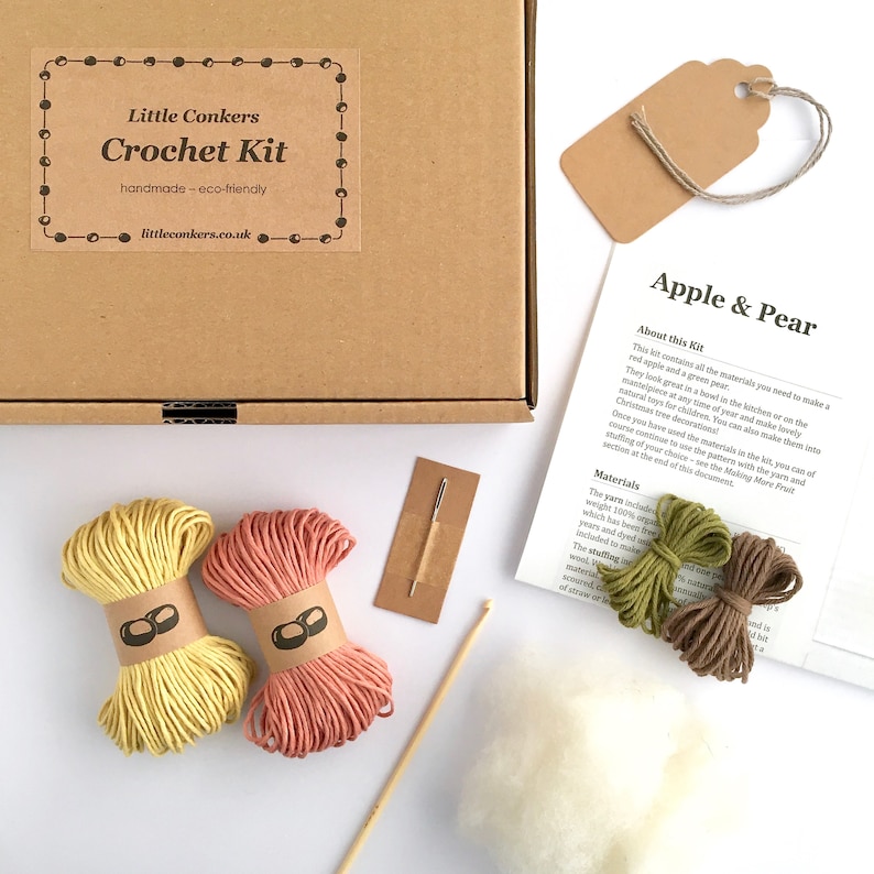 Crochet kit with yarn, stuffing and a crochet hook in a kraft box