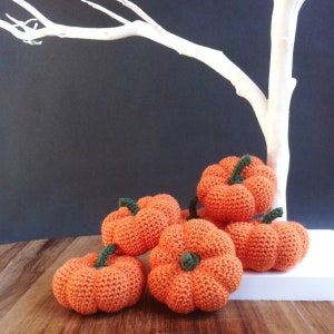 A pile of crocheted pumpkins