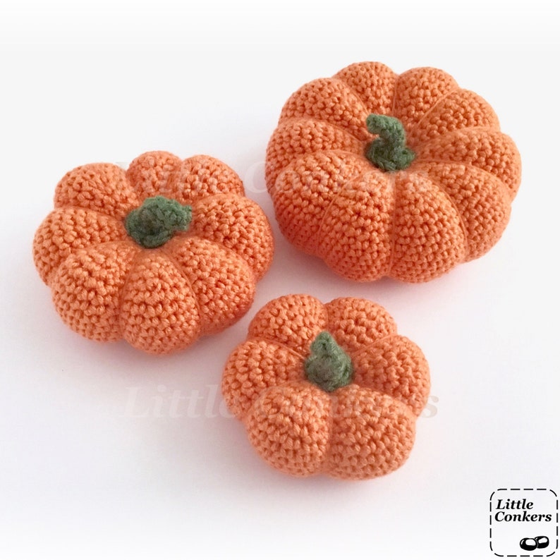 Three crocheted pumpkins in different sizes