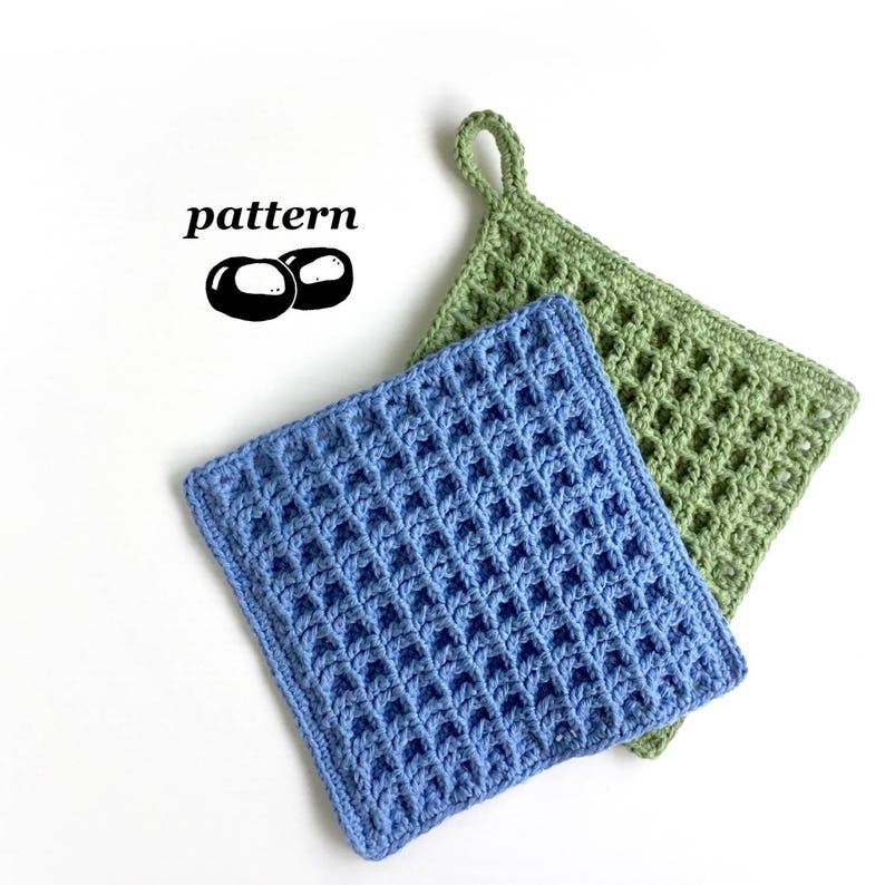 Two crocheted dishcloths, one in blue yarn, one in green yarn. The square dishcloths are crocheted with a stitch that gives them a waffle-like appearance and texture. There is a hanging loop in one corner of the dishcloths.
