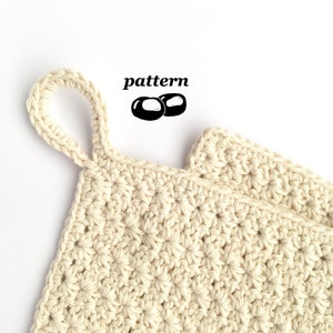May include: A beige crocheted pot holder with a loop handle. The pot holder is made with a simple stitch pattern and has a textured surface. The text "pattern" is written above the pot holder.