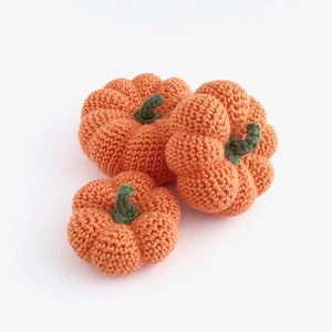 Crocheted orange pumpkins in different sizes