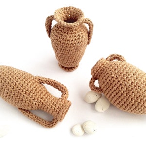 Miniature crocheted amphorae in three different styles.