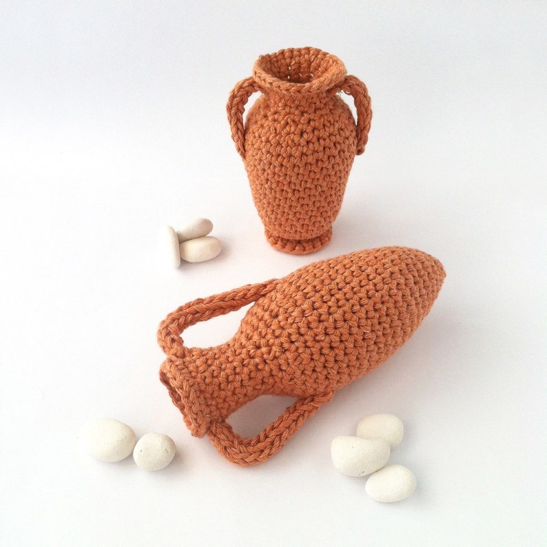 Miniature crocheted amphorae of two different styles.