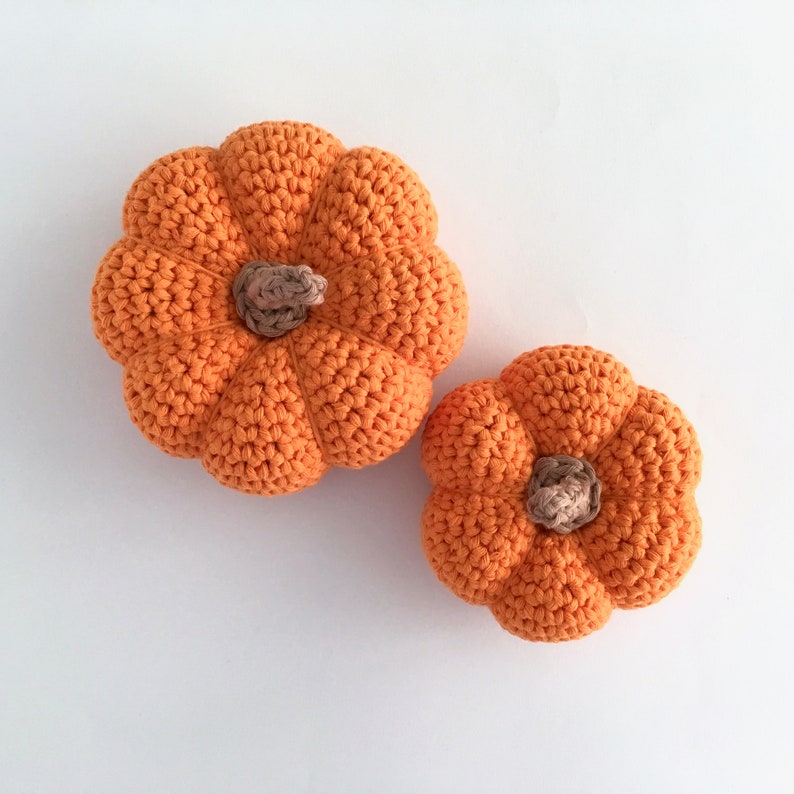 Two crocheted orange pumpkins