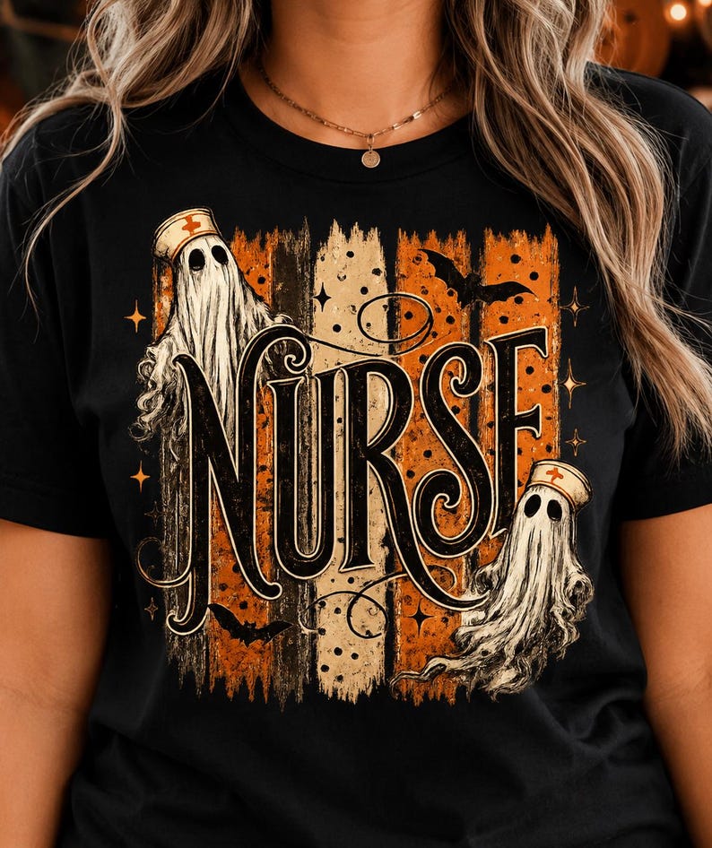 May include: A black t-shirt featuring a graphic design with the word NURSE in large black lettering. The design includes two white ghosts wearing nurse caps with red crosses, orange and black vertical stripes, bats, and small stars.