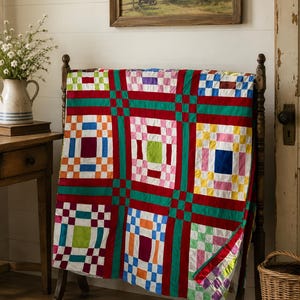 May include: A patchwork quilt featuring a grid of colorful squares in shades of red, green, blue, yellow, orange, pink, and purple. The design consists of alternating blocks with a central square surrounded by smaller squares, separated by solid red and green sashing.