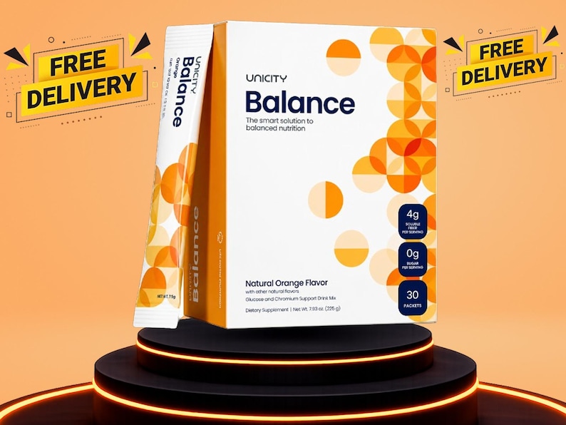 May include: A white and orange box of Unicity Balance dietary supplement drink mix with a single packet standing beside it. The packaging features orange circular patterns, text stating Natural Orange Flavor, 4g fibre, 0g sugar, and 30 packets.