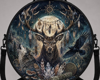 May include: A round black crossbody bag featuring a detailed graphic print of a deer with large antlers, a howling wolf, and a flying raven. The design includes a full moon, hanging feathers, crystals, and geometric symbols on a dark forest background.