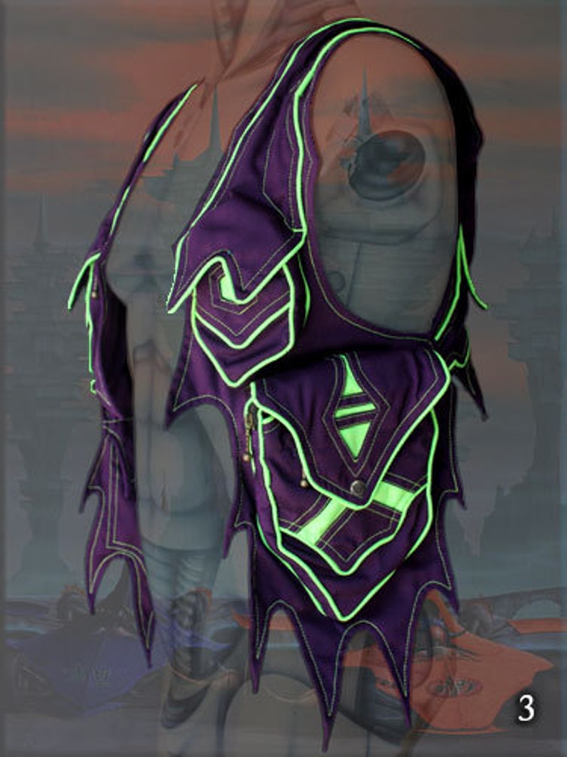 May include: Purple vest with neon green trim and a pointed, jagged design. The vest has a large pocket on the front with a diamond-shaped design.