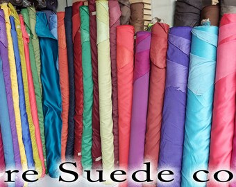 May include: A variety of suede fabric rolls in different colors, including red, pink, purple, blue, green, and yellow. The text "more Suede colors" is at the bottom of the image.