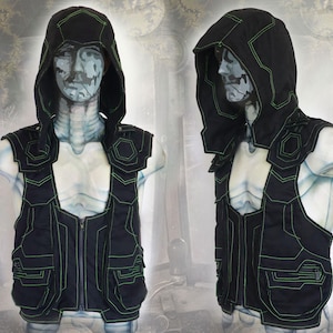 May include: Black hooded vest with green accents and a zipper closure. The vest has multiple pockets and a futuristic design.