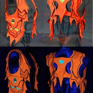 May include: A bright orange vest with black trim and neon green accents. The vest has a unique, jagged design and is shown on a mannequin in both regular and blacklight lighting.