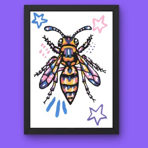 May include: A framed art print featuring a stylized wasp illustration with yellow, orange, purple, and blue segments. The wasp is surrounded by hand-drawn elements including blue and pink stars, small pink dots, and three blue vertical lines on a white background.