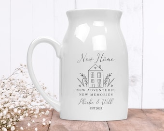 May include: White ceramic mug with a black and white illustration of a house and the text "New Home, New Adventures, New Memories, Phoebe & Will, EST 2025".