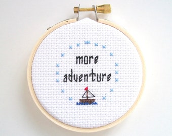 More Adventure mini cross stitch -- completed 3 inch round cross stitch about going on more adventures, maybe sailing a sailboat