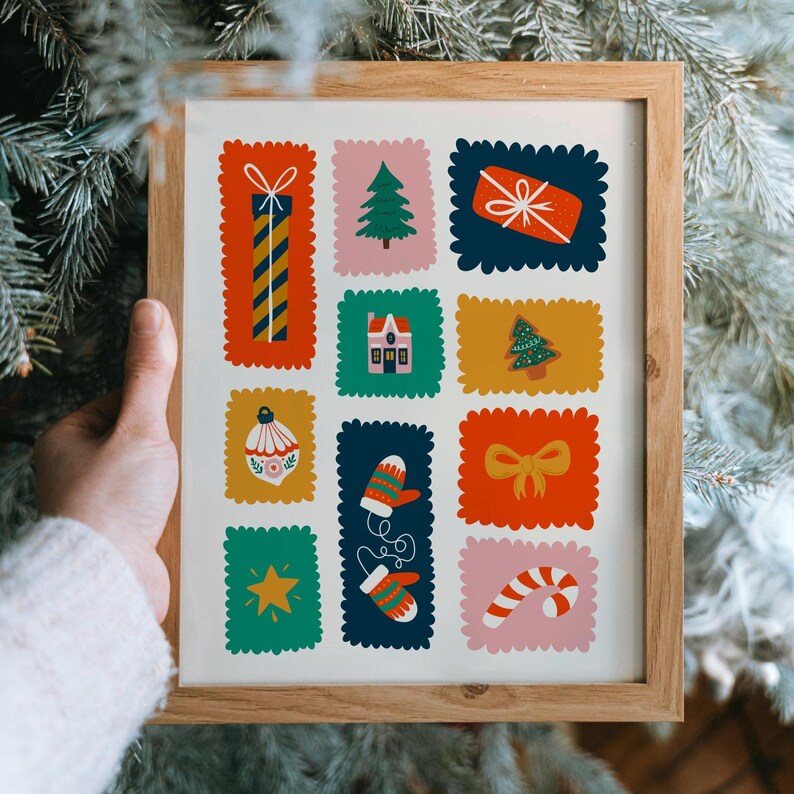 May include: A framed print featuring a grid of colorful, scalloped-edge rectangles containing holiday illustrations: a striped gift, a pine tree, a wrapped present, a house, a gingerbread tree, an ornament, mittens, a bow, a star, and a candy cane.